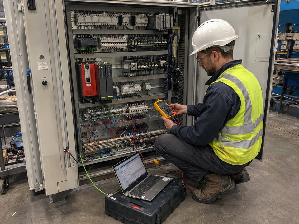 Engineer providing on-site commissioning support for an automation line.